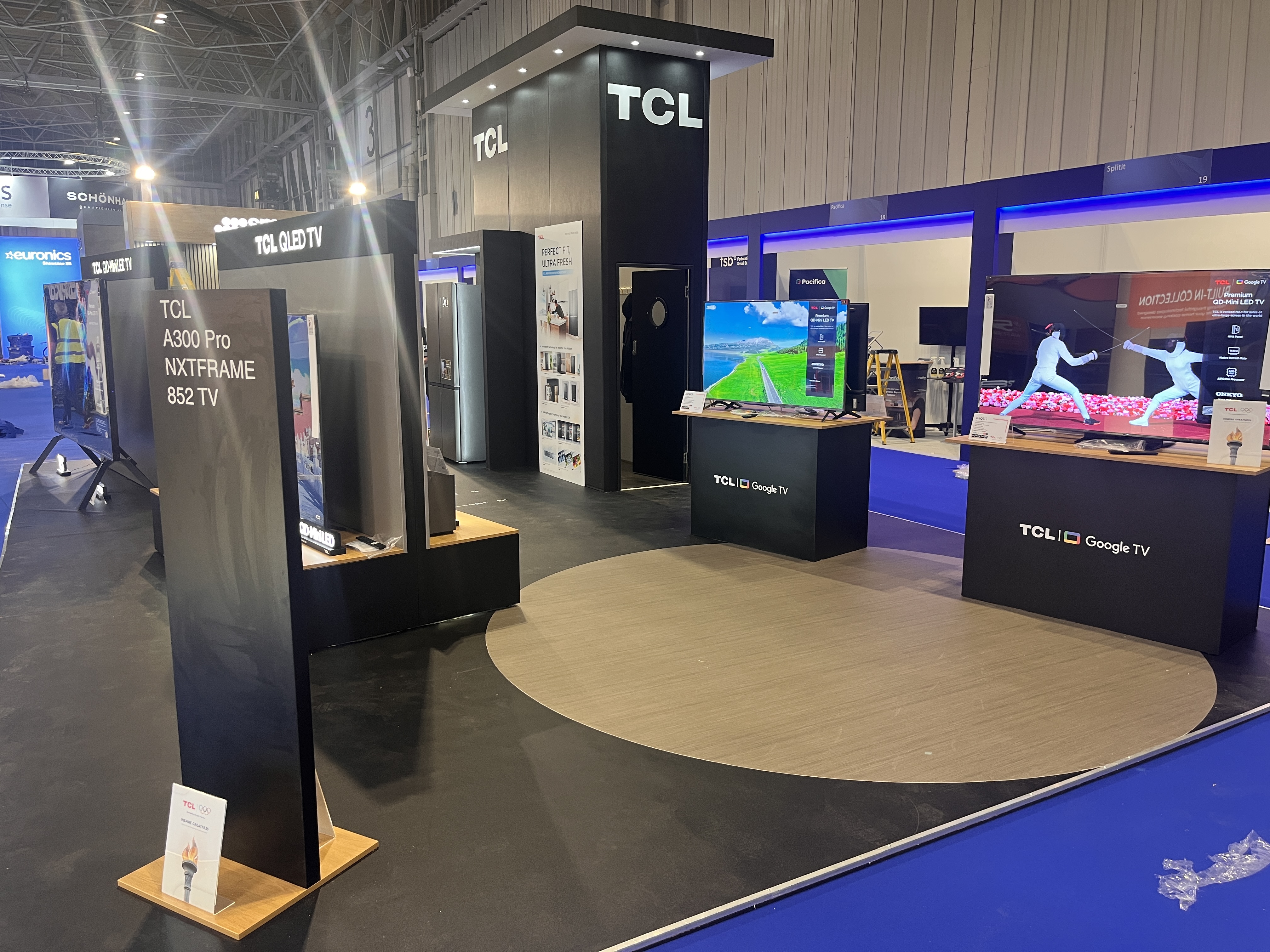TCL branded display at CIH 2025 — backlit fascia panel and branded header in exhibition configuration by Novus
